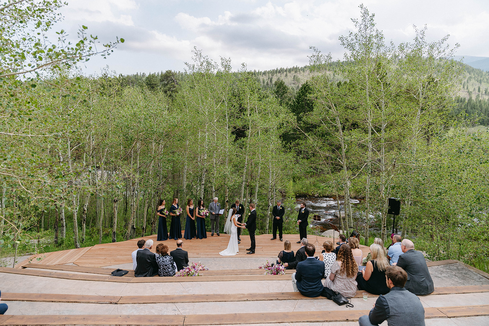 Jason and Amy kissing on the rocks framed by aspen trees